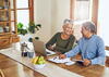 Retired couple at table looking at finances